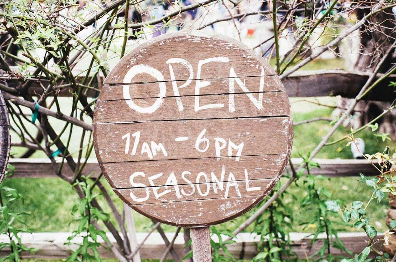 Gate Sign Displaying "Open 11am–6pm Seasonal". Definitely a company in need of a local business website.